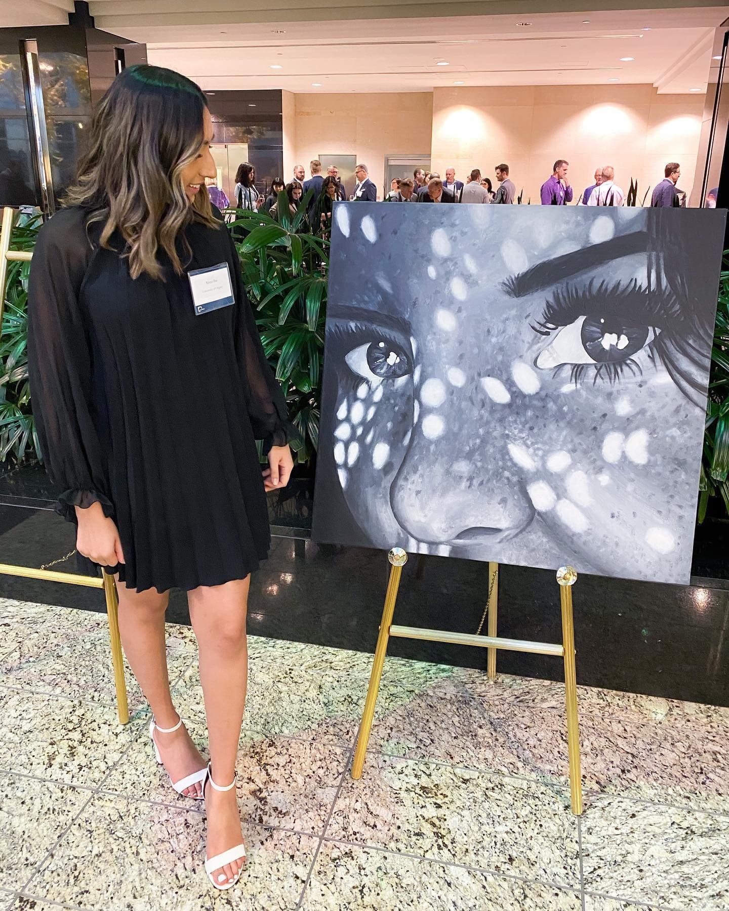 Kiran Rai-Bhullar standing beside Curiosity on an easel