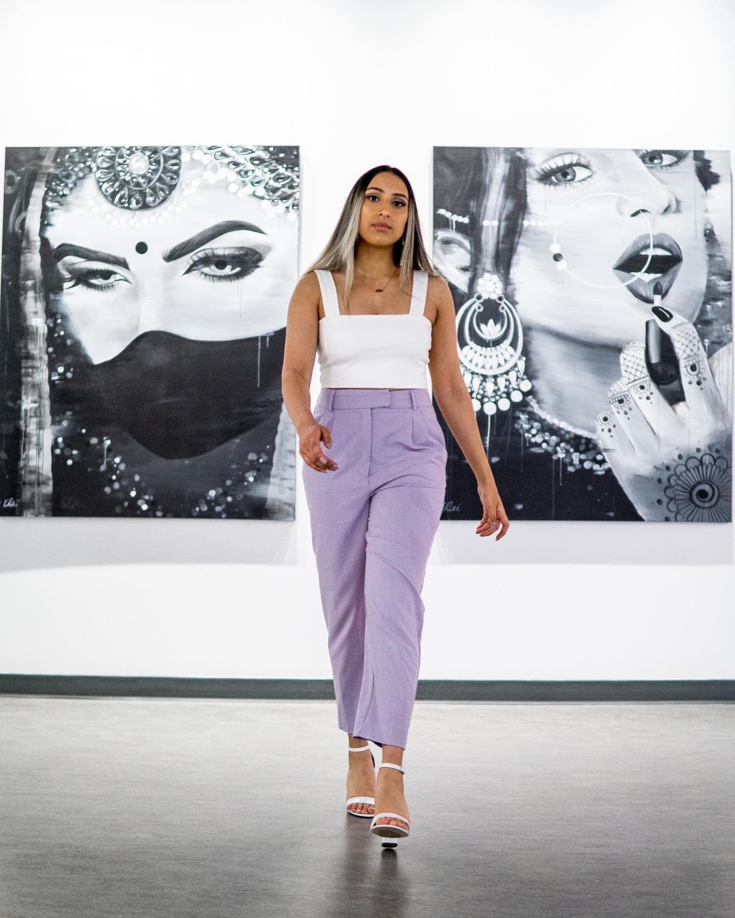 Kiran Rai-Bhullar in the gallery between the black and white paintings Masked Maharani and Make Up Your Mind Maharani