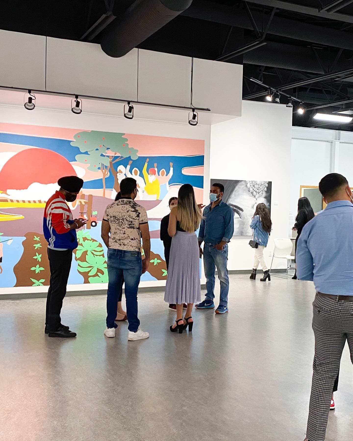 Guests gathered in front of the Love for Humanity mural on opening night