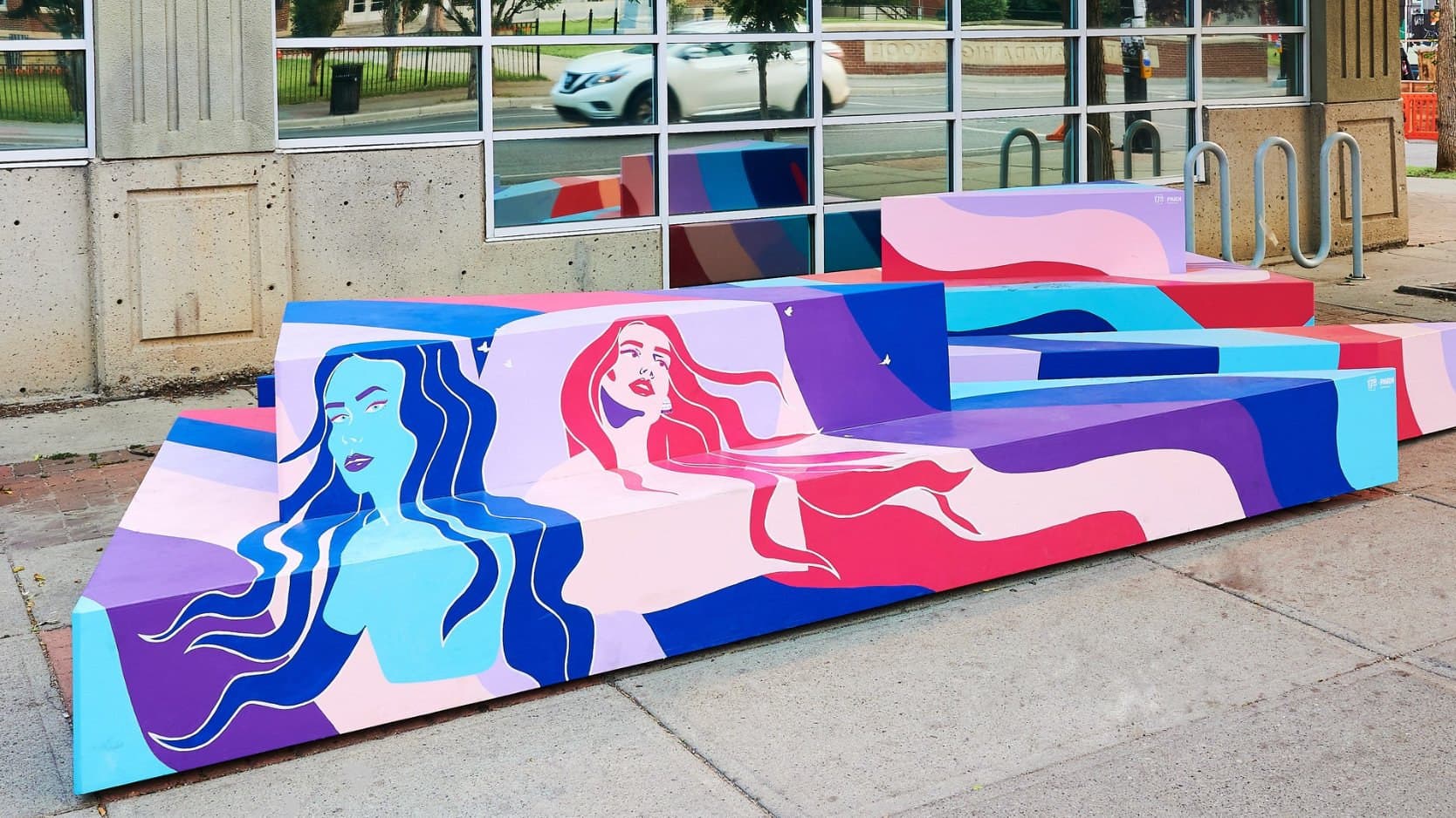 Freeflow on 17 Ave SW, Calgary: street benches painted with flowing blue and pink figures