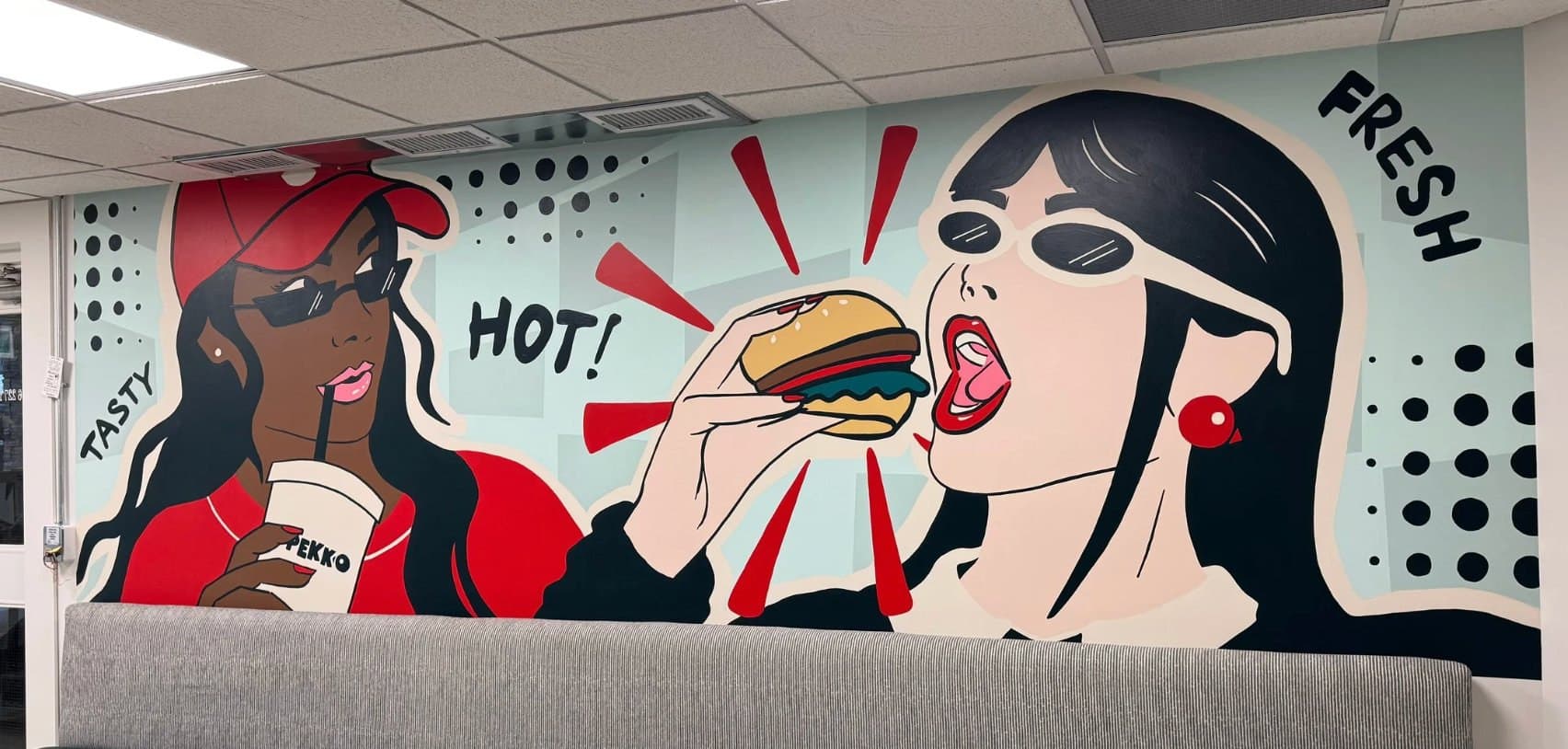 Pekko in Kensington, Calgary: two pop-art women, one with a drink, one biting a burger, with HOT! and FRESH lettering