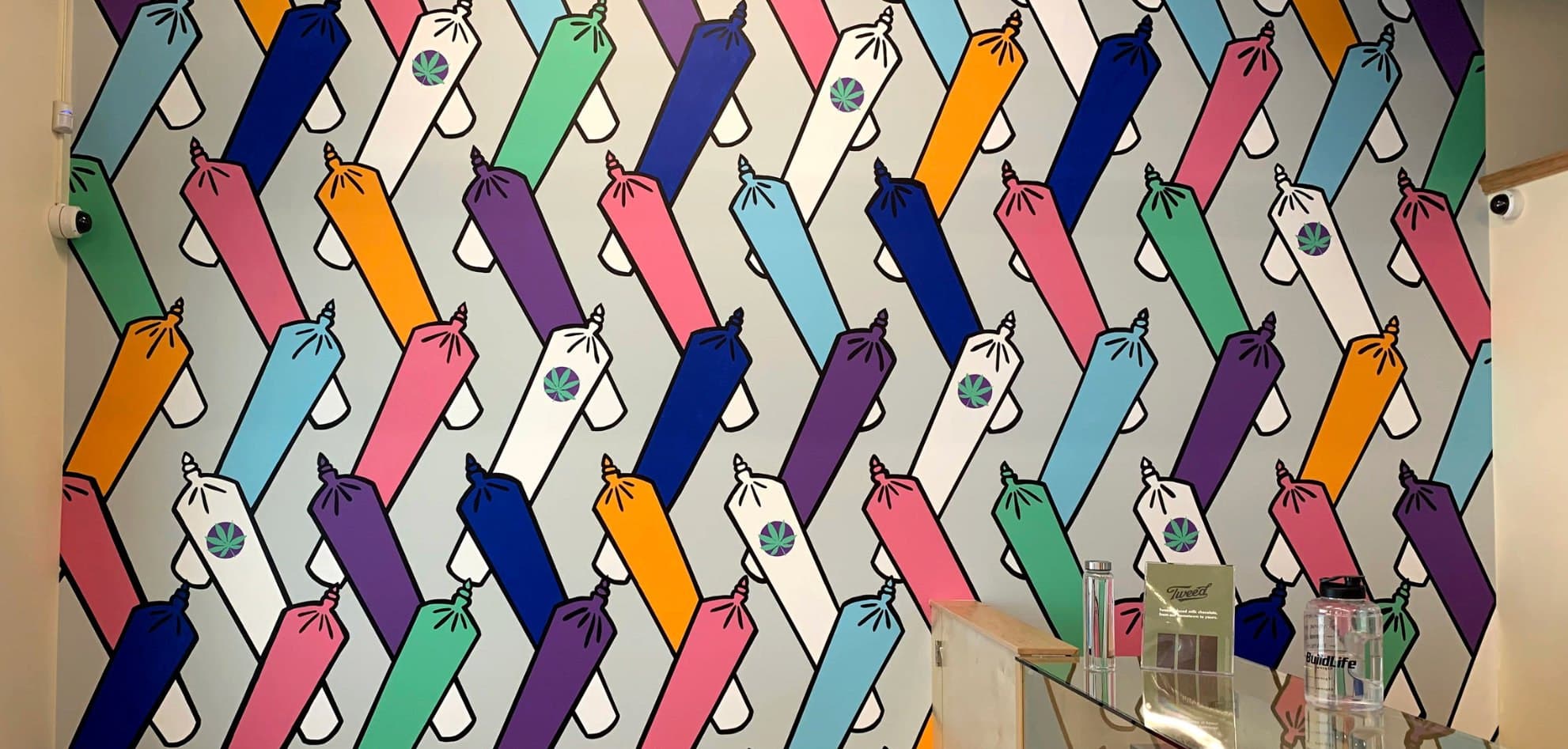 Rainbow Doobies at Bud Mart Cannabis in Bayside, Airdrie: rows of joints in rainbow colours in a repeating zigzag