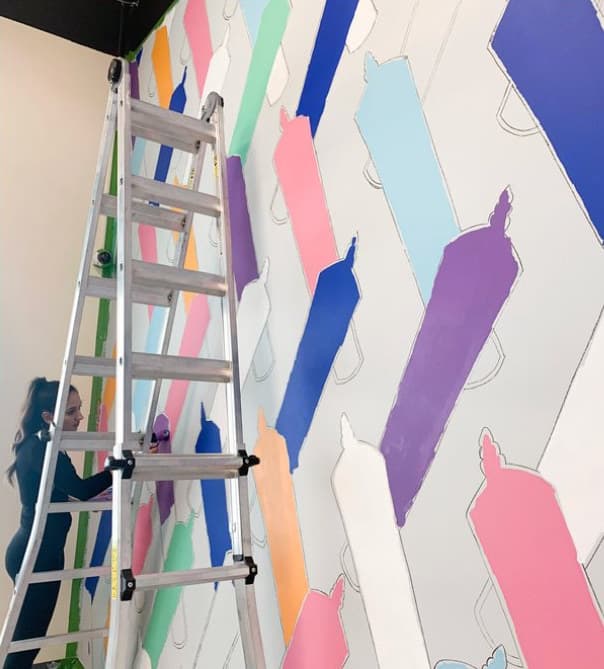Rainbow Doobies in progress: a ladder against the wall, the colours blocked in before the outlines