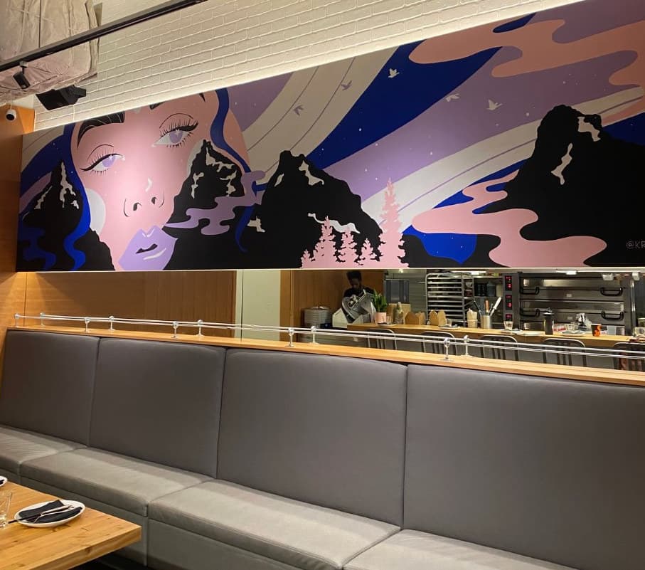 Uprooted seen from the right: the woman's face and dark peaks above the banquette
